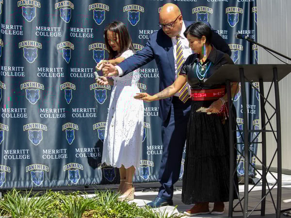 Chancellor Gilkerson, President Johnson, and Merritt student Marquel de la Cruz honor the Ohlone at the Horticulture Complex Ribbon Cutting ceremony