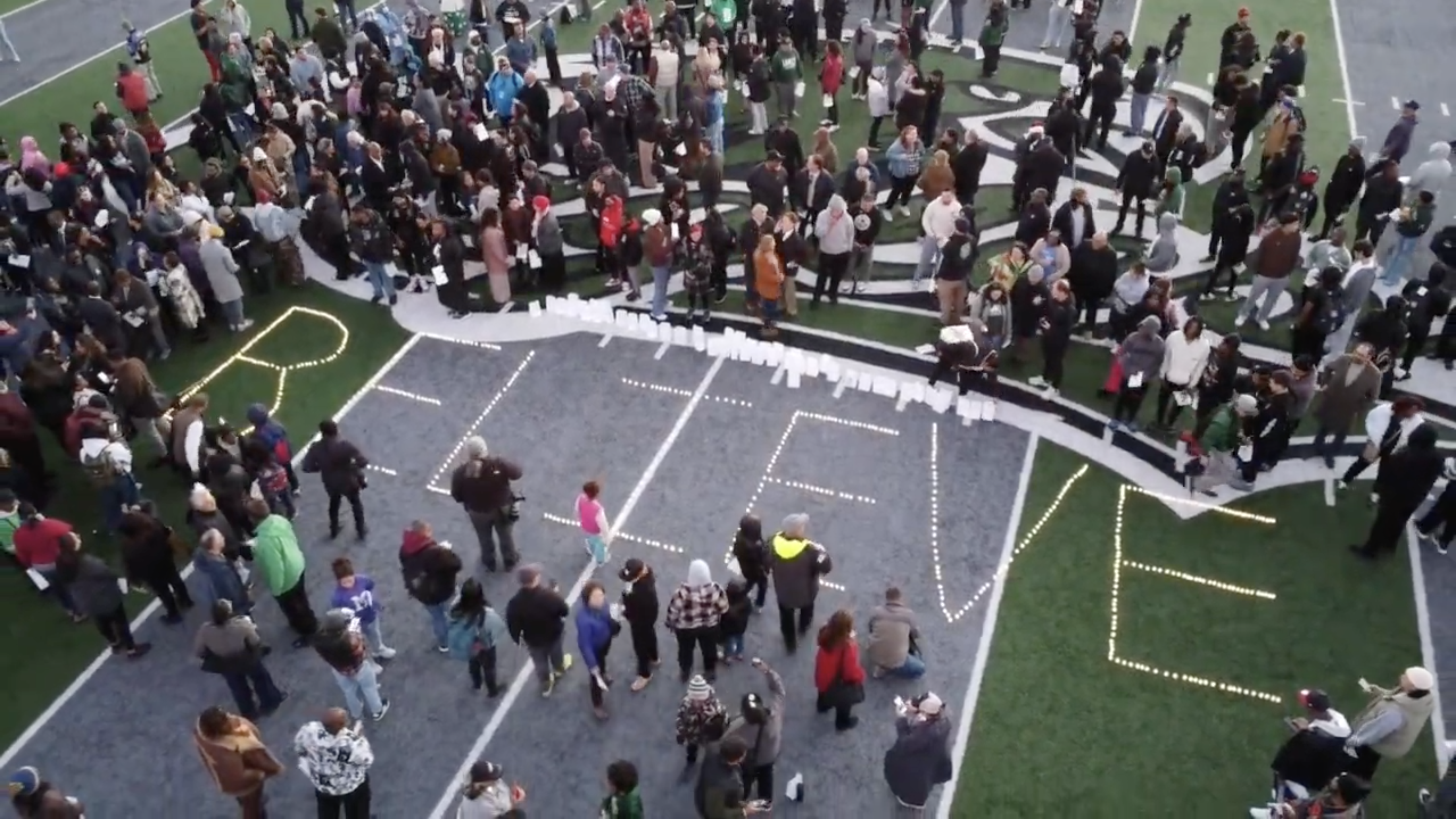 The word BELIEVE is spelled out with luminaria on the Laney College football field in memory of John Beam