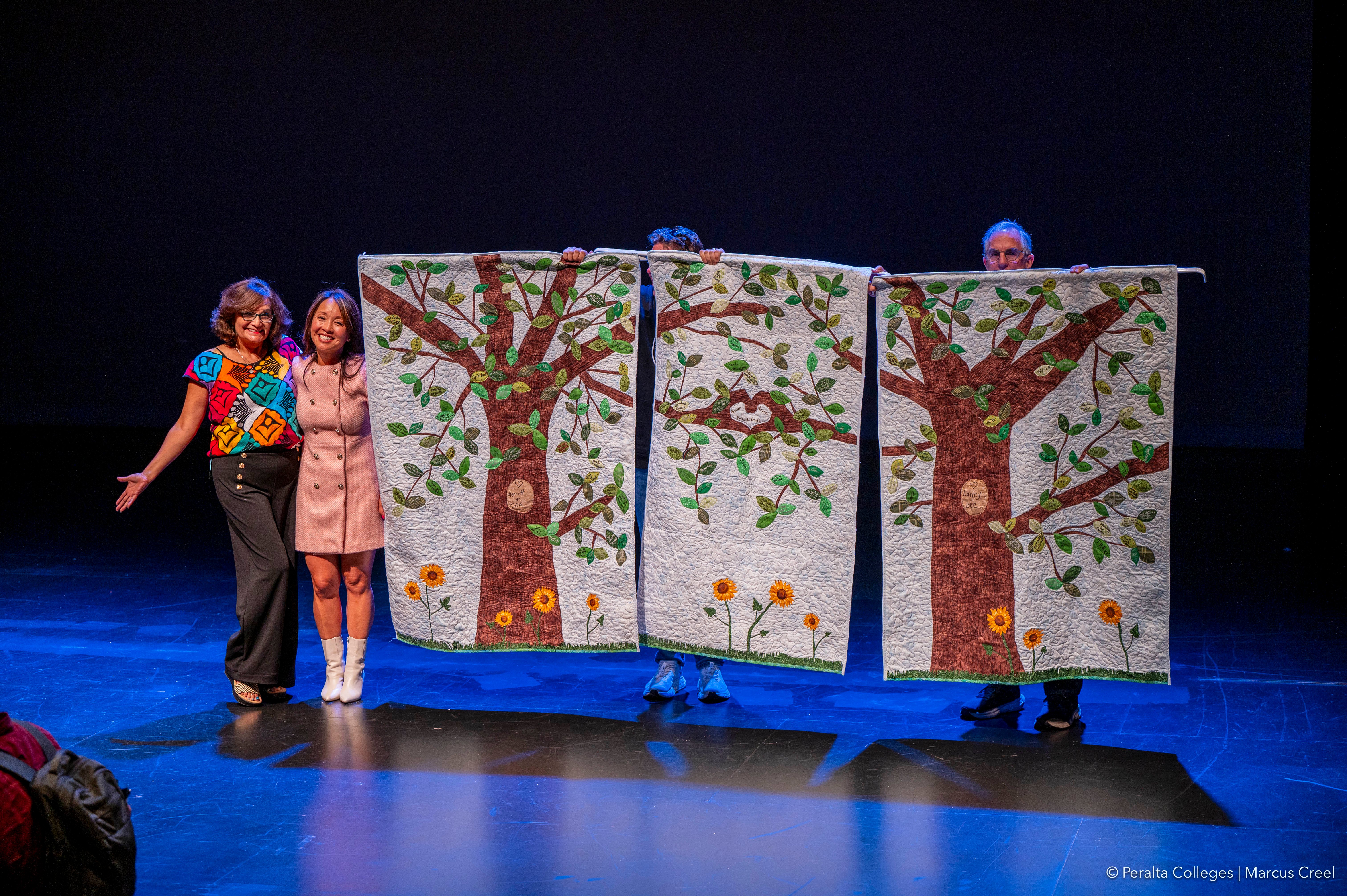 Master Quilter Laura Leon-Maurice and Peralta Chancellor Dr. Tammeil Gilkerson unveil the new Peralta quilt created collaboratively by employees