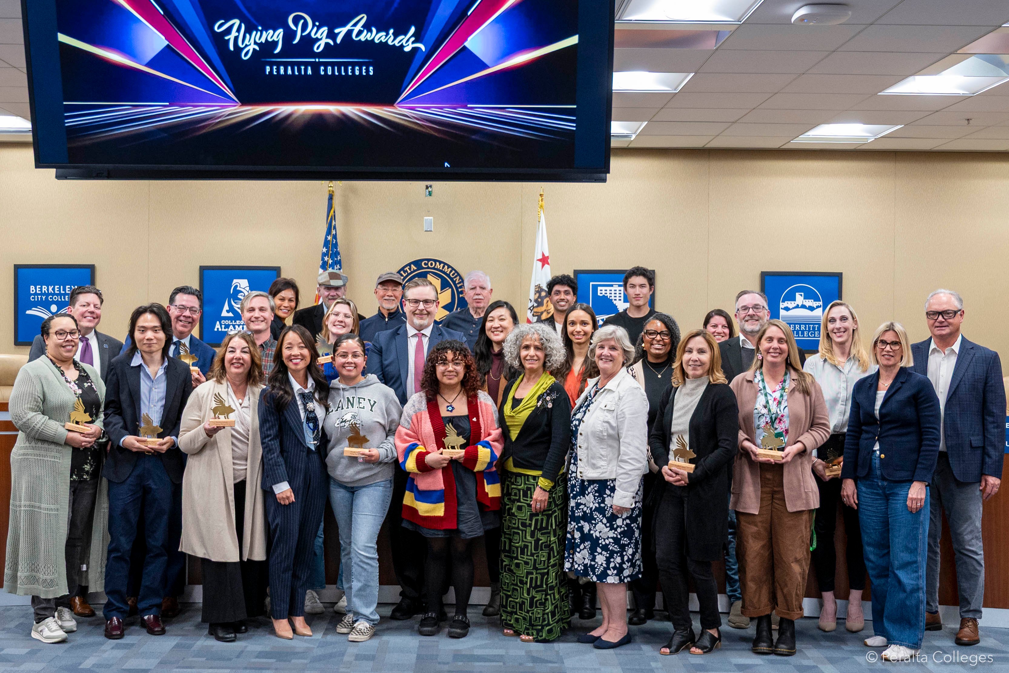Nearly 30 people are standing and smiling - they are Chancellor Gilkerson and the 2026 Flying Pig Award winners with the Board of Trustees