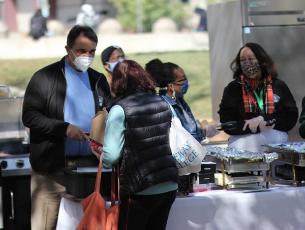 President Besikof serving food for the community