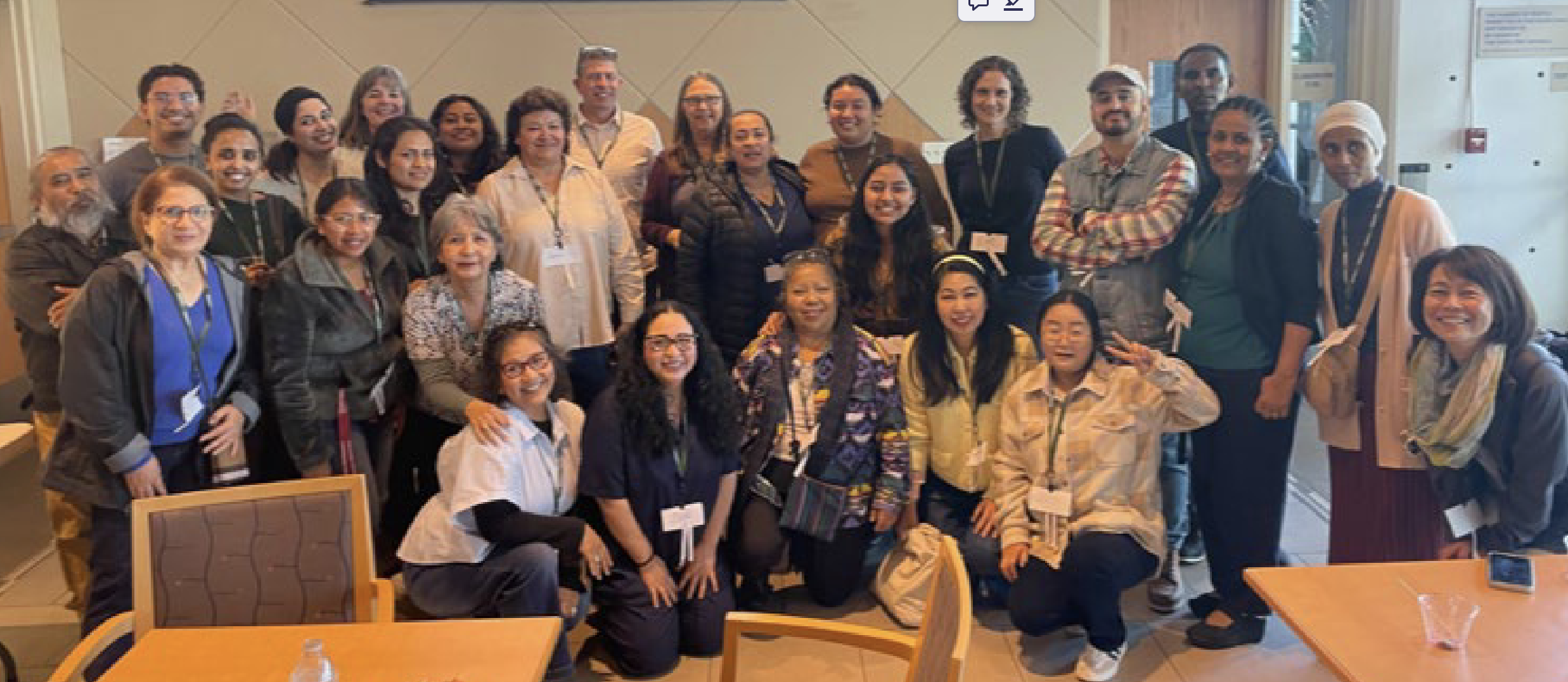 About 25 smiling Laney College students smile as part of the English Language Learners Healthcare Bridge cohort in 2026