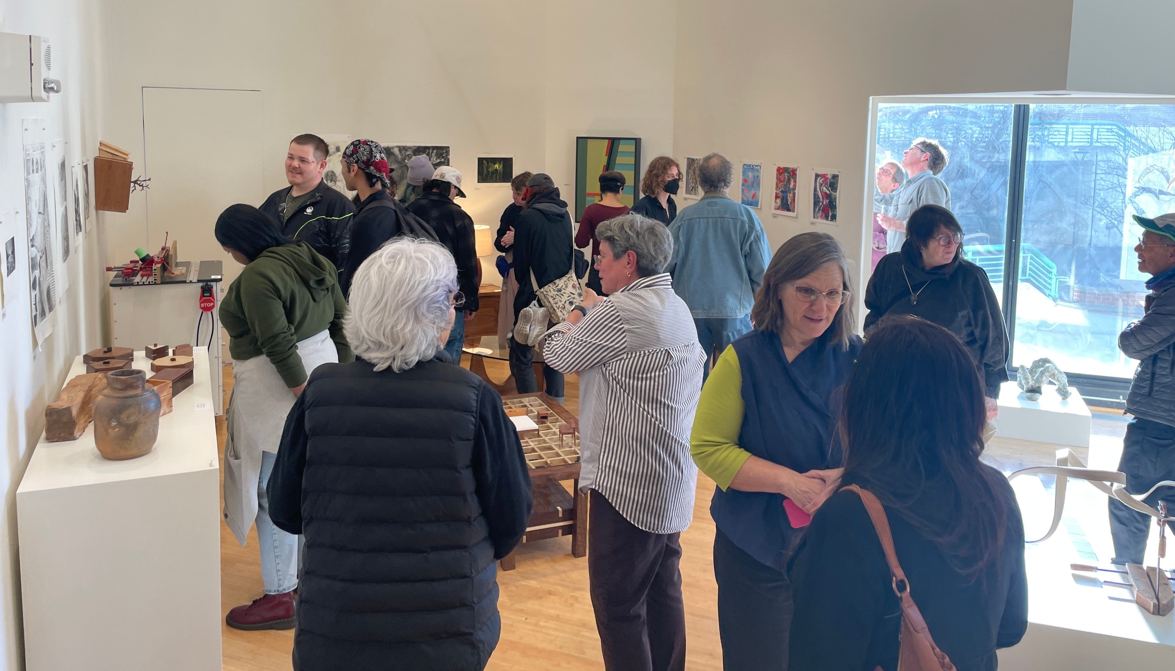 many patrons look at the artworks in the Laney College art gallery