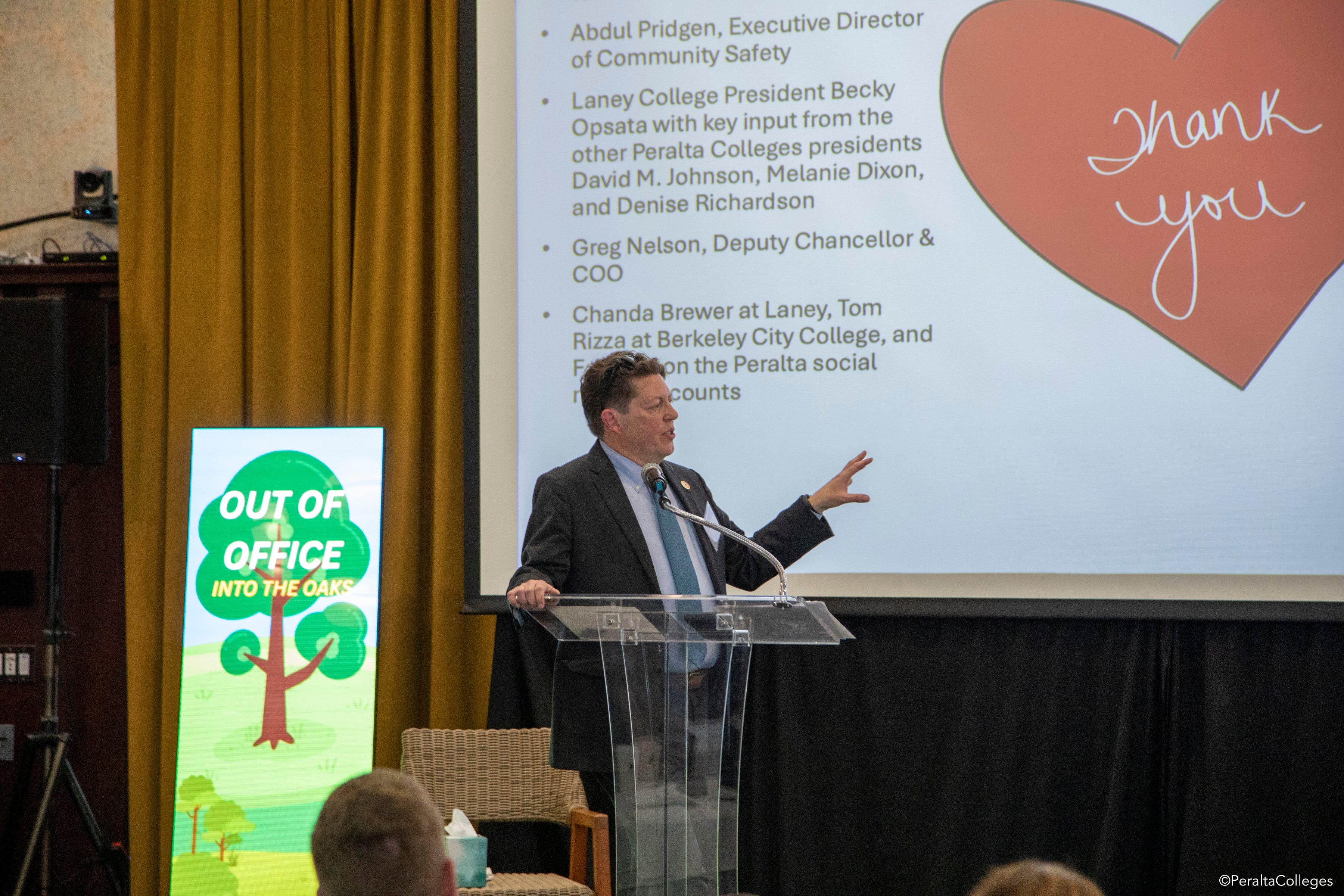 Man in a suit and tie gesturing with left hand while speaking in front of a powerpoint slide that says "thank You." The man is Mark Johnson giving a talk at CCPRO 2026