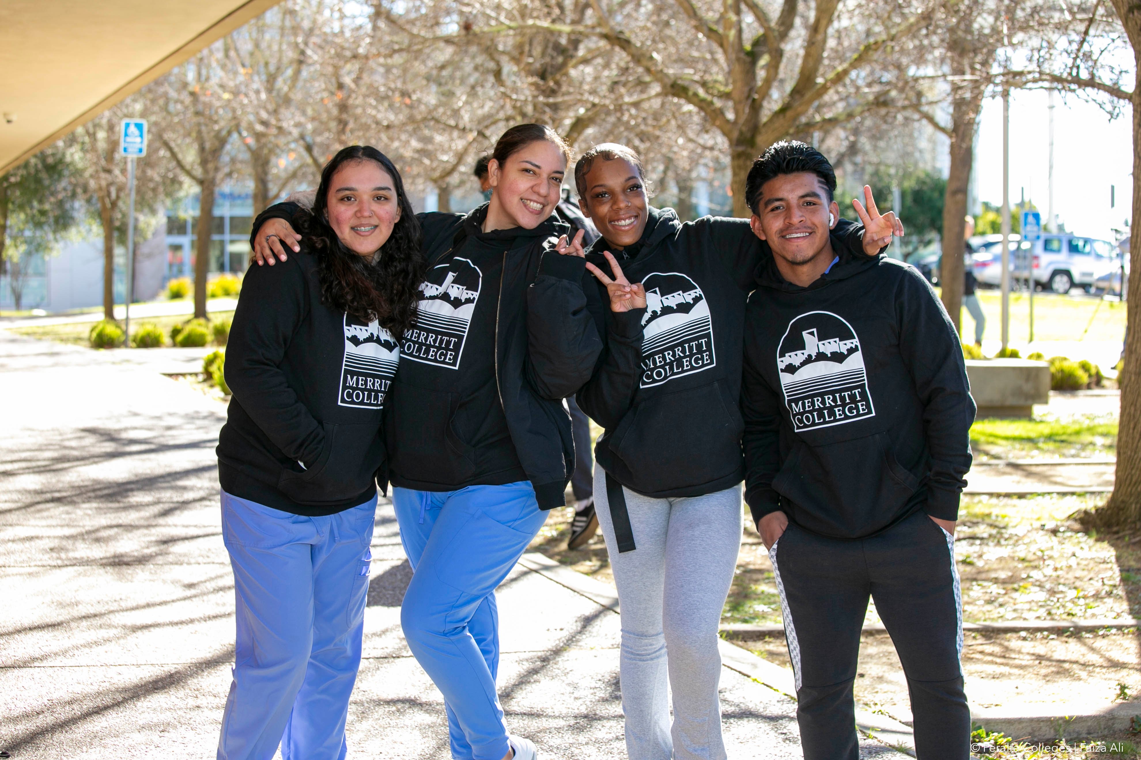 Merritt College students model their new hoodies