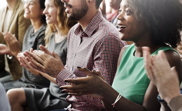 People Smiling and Clapping