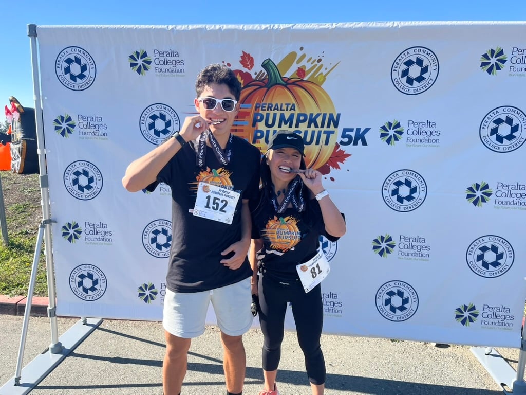 Student Trustee Léo Migliaccio and Chancellor Dr. Tammeil Gilkerson celebrate their finish of the Peralta Pumpkin Pursuit