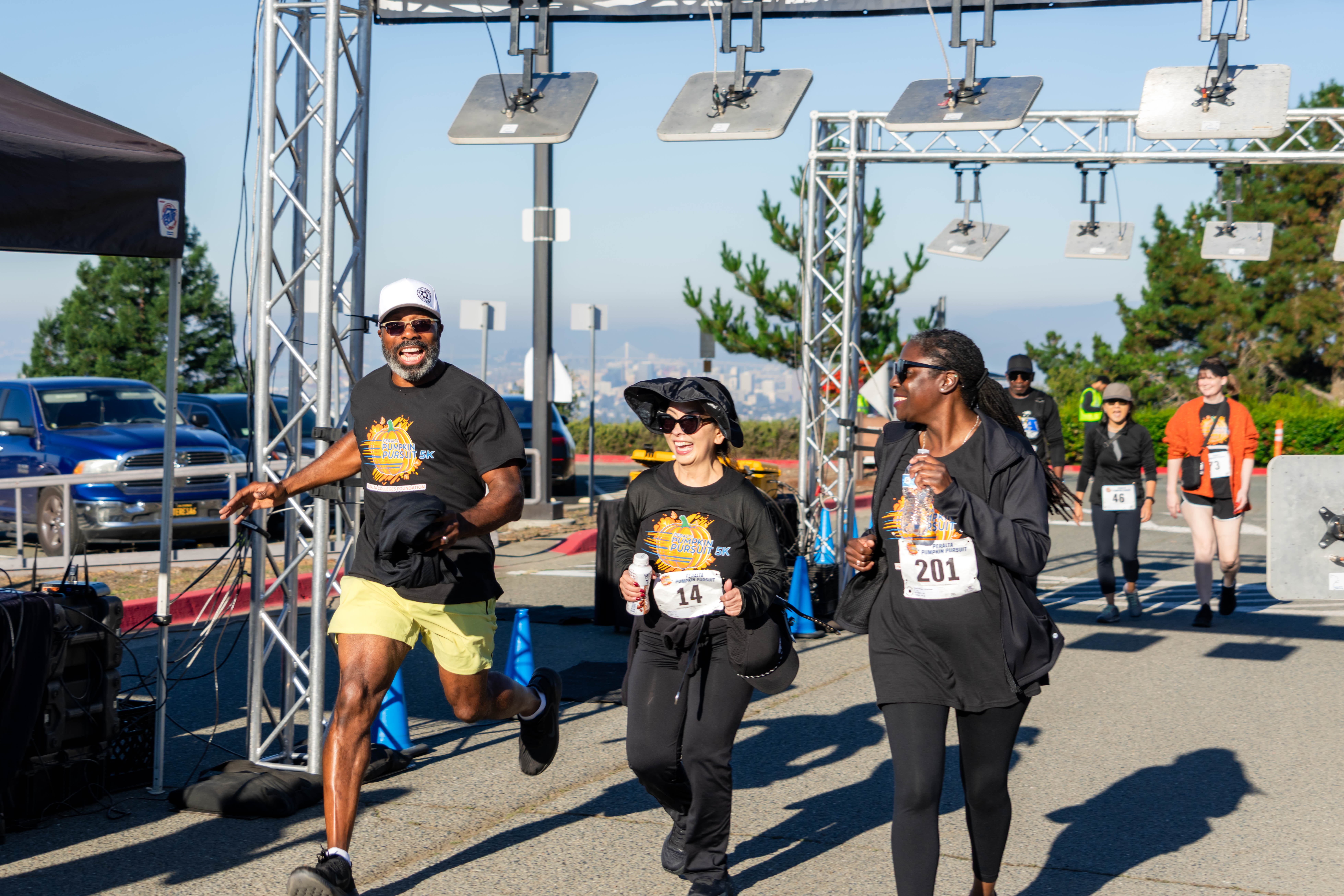 Participants happily cross the finish line of the Peralta Pumpkin Pursuit 5K