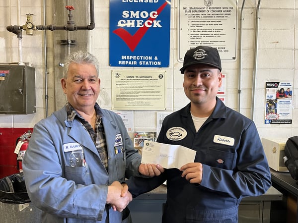 Roberto Reyes (right) receives Ozzie Day Scholarship check from College of Alameda Automotive Technology Professor Rufino Ramos