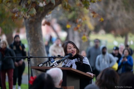 Dr. Tammeil Gilkerson speaking outside at the Laney Bistro patio at "Light the Path, Light the Field: A Luminaria Walk Honoring the Legacy of John Beam"