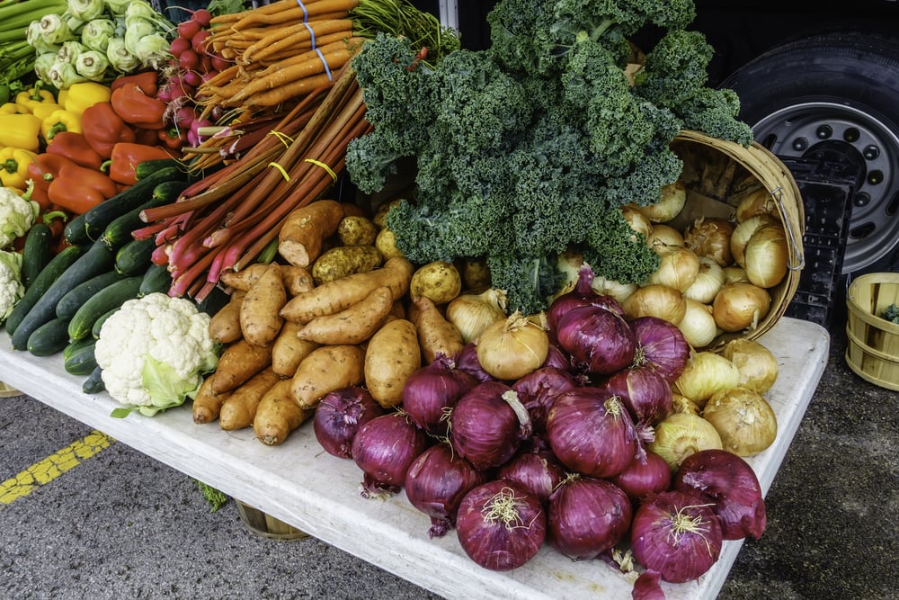 Variety of fresh vegetables on display at a farmers market, late spring in northern Illinois, USA