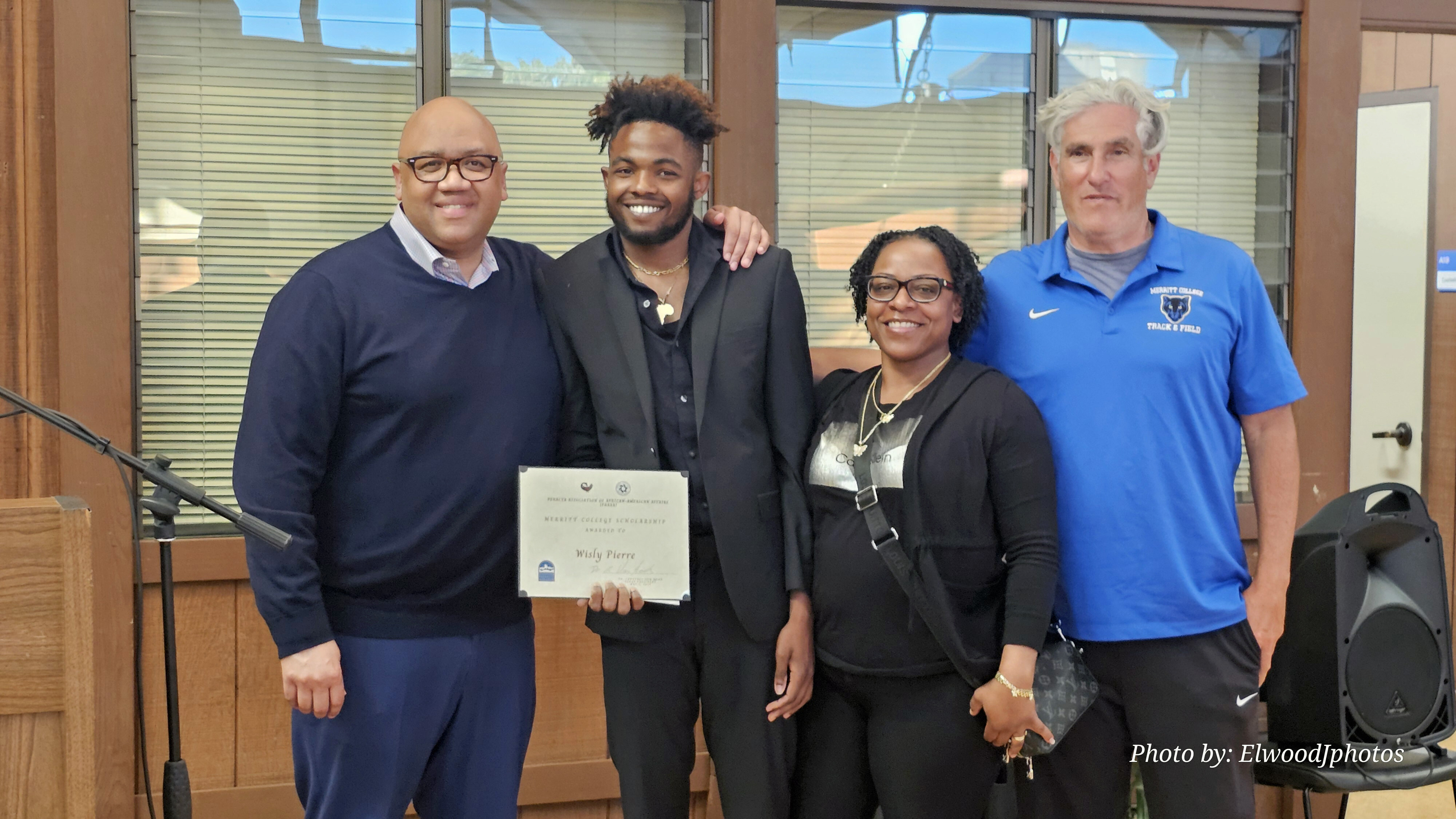 Merritt College President Dr. David Johnson presents a PAAAA Scholarship Award to student Wisly Pierre, with Tauheeda Anderson and Brock Drazen
