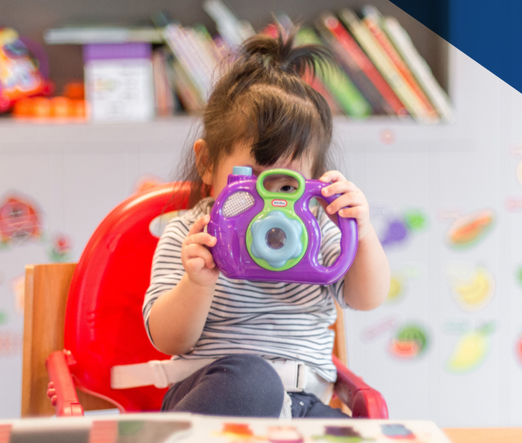 young child with toy camera